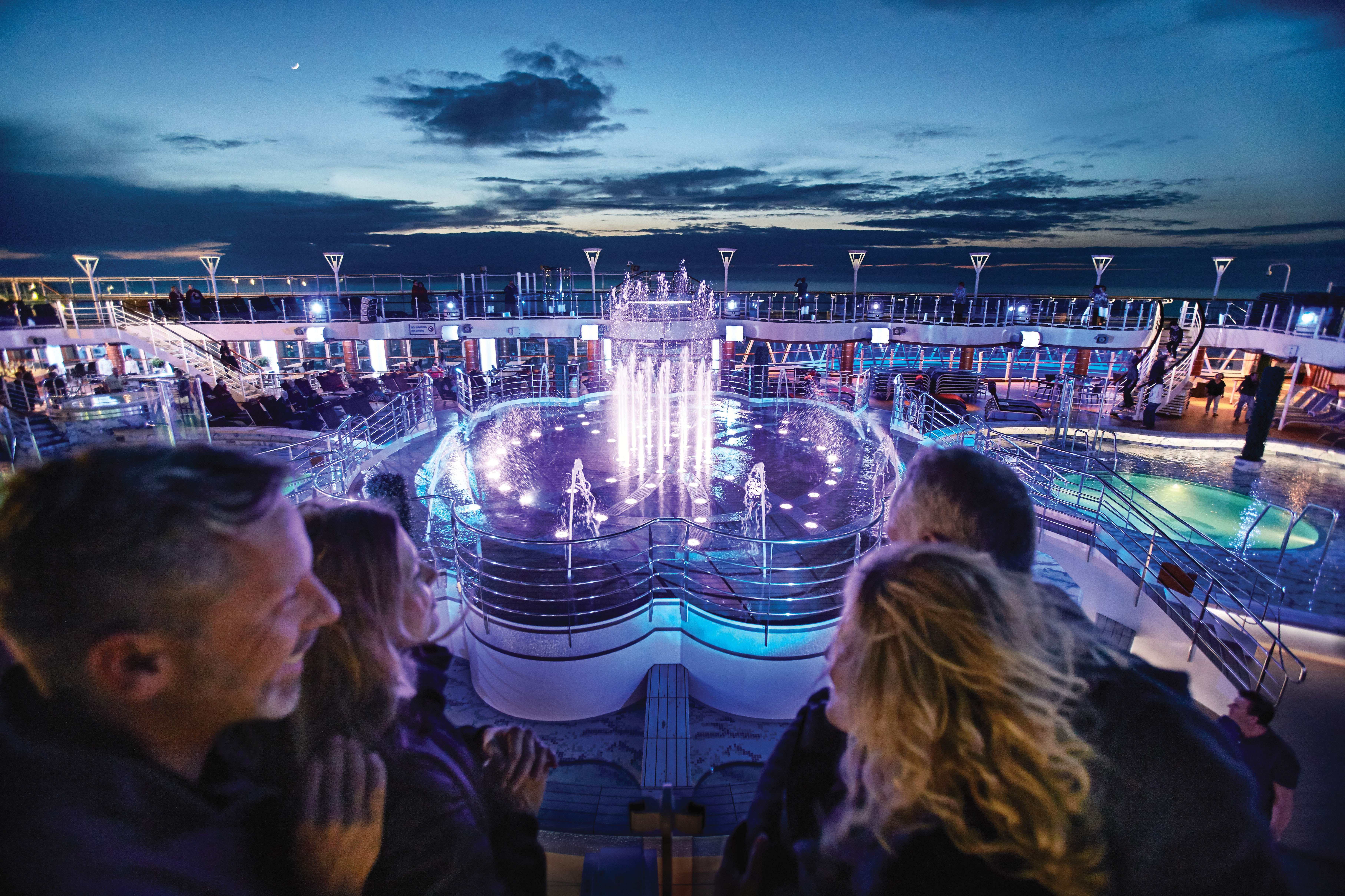 A glittering water show on the pool deck choreographed with colors and music