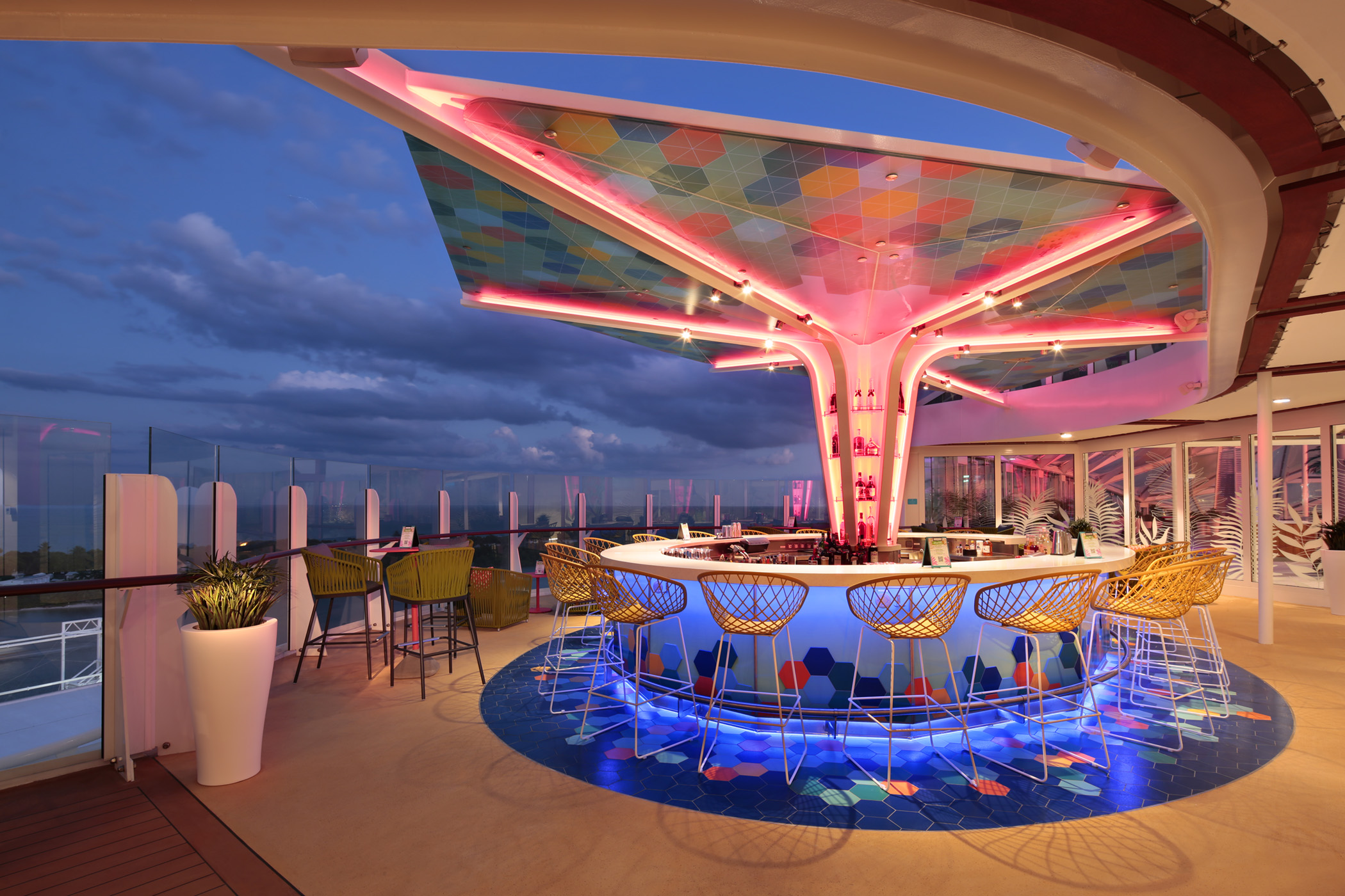 Enjoy a cocktail in The Vue Bar - the bar has a colorful mosaic canopy overhead after sunset