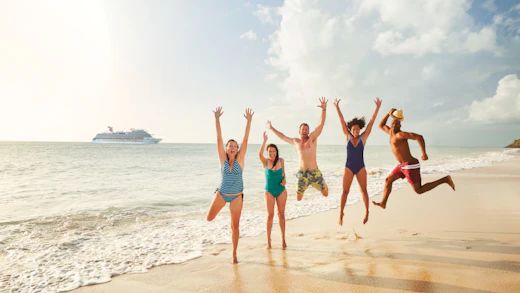 Carnival Guests jumping for joy with ship in the background