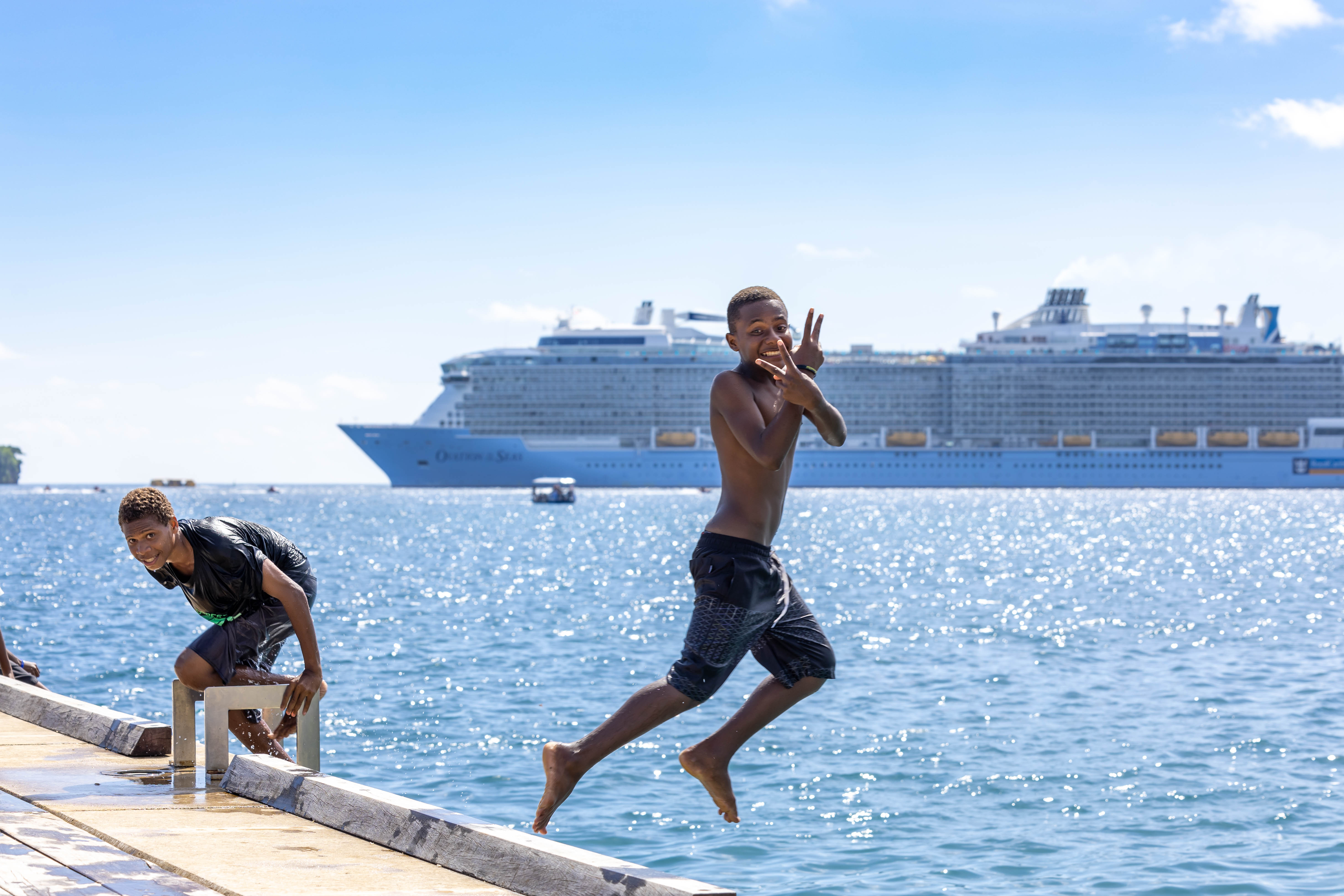 Boys jumping off wharf in Vanuatu