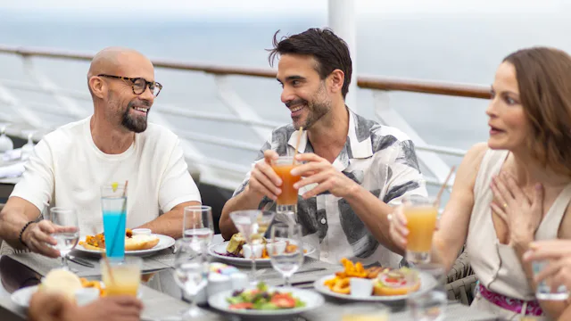 Friends lunching at the onboard Sunset Bar & Grill